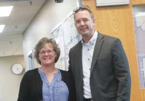 Travis Duley, superintendent of the Paxton-Buckley-Loda school district, poses with retiring staff member Kara Harrison as she was recognized during last week’s board meeting.