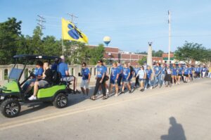 Led by a golf cart driven by PBL High School head football coach Josh Pritchard, with Amy Johnson, the teachers’ union president, in the passengers seat, PBL teachers and support staff march Tuesday on Holmes Street. Andrew Rosten/Ford County Chronicle