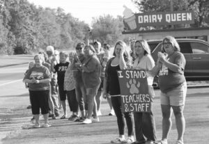 Supporters stand along U.S. 45 as certified teachers and educational support staff at Paxton-Buckley-Loda schools walkTuesday morning from Kirchner Building Center in downtown Paxton to the Pueblo Lindo Mexican restaurant, where an all-staff teacher institute was held. The demonstration of unity was organized by the PBL Education Association teachers’ union, which continues to negotiate terms of a new collective bargaining contract with the school board, which meets at 6 p.m. Wednesday, Aug. 13, at the unit office in Paxton. Andrew Rosten/Ford County Chronicle