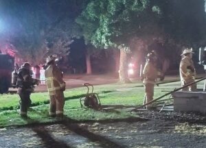 Firefighters respond to a two-story home at 310 N. Melvin St. in Gibson City that caught fire late Friday night, sustaining an estimated $15,000 in damage. An estimated 25 firefighters from Gibson City and Elliott responded to the scene with eight fire trucks. Photo by Christina Lorenzen
