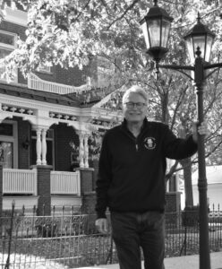 Royce Baier stands outside of the Paxton home that he shares with his wife, Sheila.